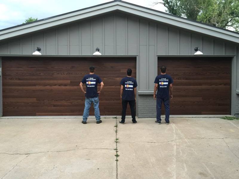 Man standing in front of faux wood garage doors